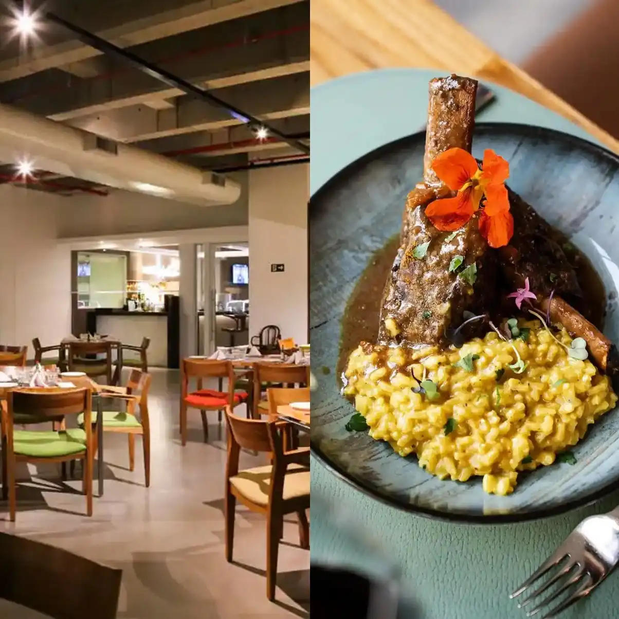 Imagem de restaurante aconchegante com mesas de madeira e cadeiras coloridas, além de um prato gourmet de risoto com carne e decoração de flores.